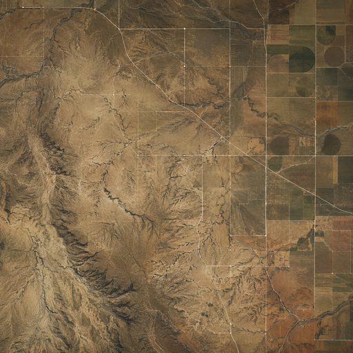 Aerial view of eastern New Mexico and West Texas rangeland, section roads and center-pivot fields cut by arroyos